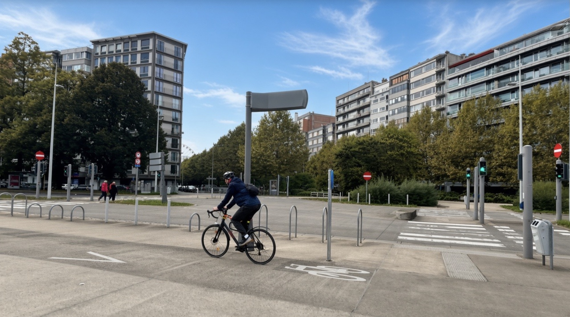 A person cycling across a city junction