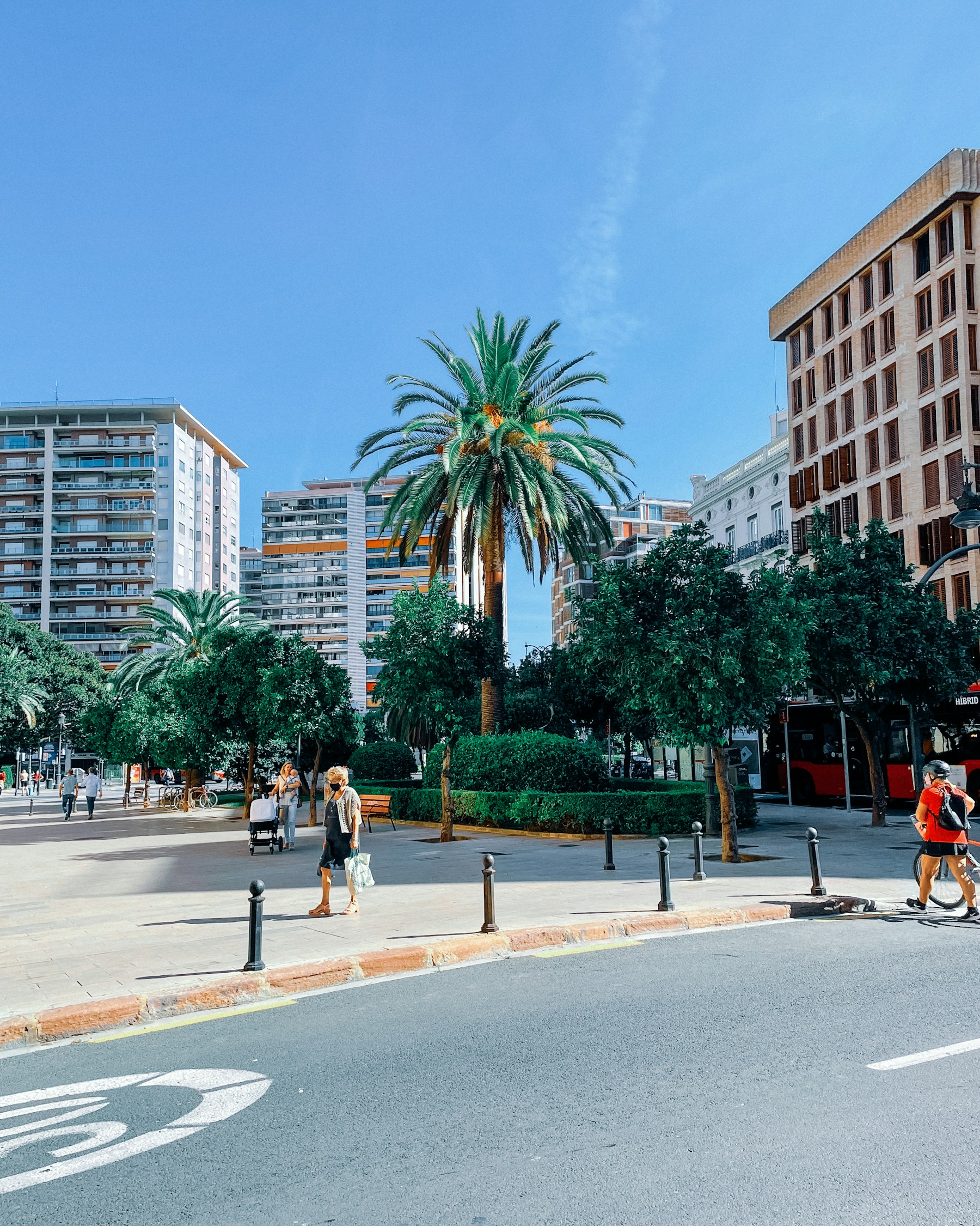 People crossing a sunny street in Valencia